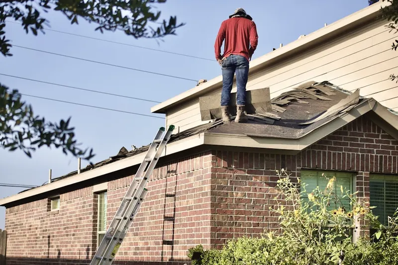 Professional roofer working on a residential roof in Asheville